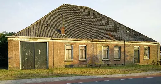 Lange voorgevel van de boerderij aan de wegkant, 26 mei 2018.