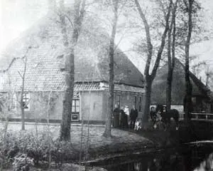 Voor de stolpboerderij 't Oude Nest, gelegen aan de Gouwe bij Hoogwoud, poseert de familie Slagter.
